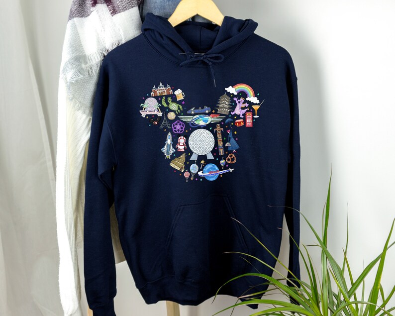 May include: A navy blue hoodie featuring a white graphic print of a Mickey Mouse head filled with various Disney park icons, including Spaceship Earth, Cinderella's Castle, and a rainbow.