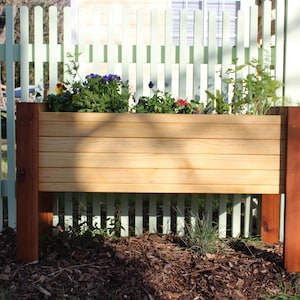 buyers can build this waist high raised garden bed with in depth plans that guide you through the entire process with written text and images