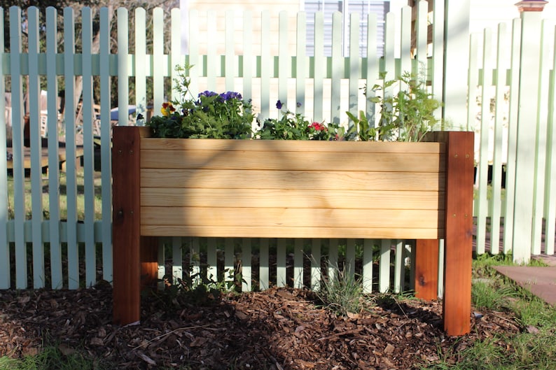buyers can build this waist high raised garden bed with in depth plans that guide you through the entire process with written text and images