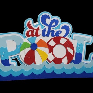 Pode incluir: Uma arte de papel azul e branco com as palavras "at the pool" e um salva-vidas vermelho e branco e uma bola de praia colorida.