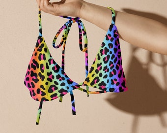 May include: A rainbow leopard print bikini top with adjustable straps.