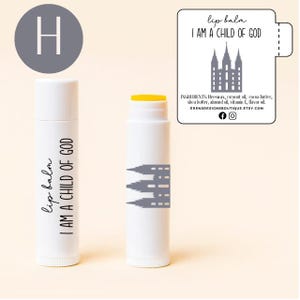 May include: Two white lip balm tubes with the text "lip balm I AM A CHILD OF GOD". One tube has a yellow top. A label reads "lip balm I AM A CHILD OF GOD" with ingredients and a church graphic.