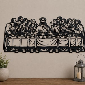 May include: A black metal wall art piece depicting the Last Supper, featuring a central figure with a crown of thorns seated at a long table with twelve individuals, all rendered in a detailed silhouette style with visible plates and cups.