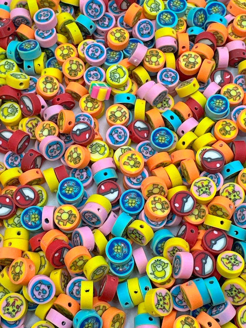 May include: A vibrant assortment of colorful, round beads. The beads feature various cartoon character designs in shades of red, orange, yellow, blue, and pink. These beads are ideal for crafting and jewelry making.