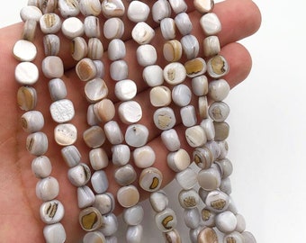Peut inclure: Un brin de perles carrées en coquillage blanc et brun. Les perles ont un aspect naturel et organique et sont parfaites pour la fabrication de bijoux.