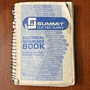May include: A spiral-bound electrical reference book from Summit Electric Supply. The cover is white and blue with the company logo and the text "Electrical Reference Book." It includes topics like wiring, formulas, and diagrams. Updated for the 2002 National Electrical Code.