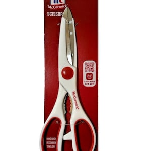 May include: White and red McCormick kitchen shears on a red background. The shears have a stainless steel blade and a white handle with red accents. The packaging includes the McCormick logo and the word "SCISSORS".