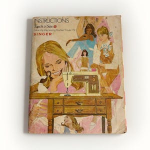 May include: A vintage instruction manual for a Singer Touch & Sew Deluxe Zig-Zag Sewing Machine Model 758. The cover features a faded illustration of a sewing machine on a wooden table surrounded by drawings of people in various outfits.