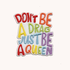 May include: Embroidered iron-on patch with the text "Don't be a drag, just be a queen" in rainbow colors.