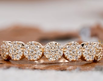 May include: A gold band ring with a row of round pave-set diamonds.