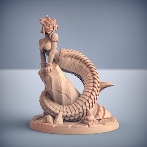 May include: A tan-colored figurine of a smiling woman with a snake tail, resting on a rock. The figure has a detailed scaled tail, adorned with jewelry, and is posed on a base with skulls and rock formations. The figurine is a fantasy-themed item.