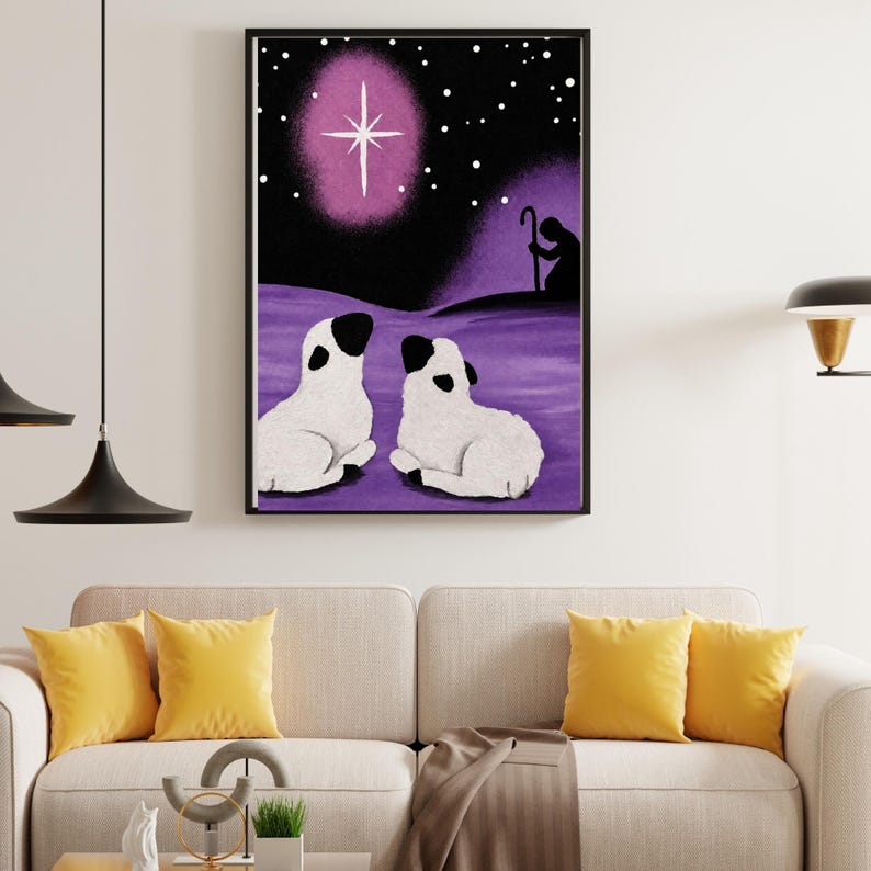 May include: A framed wall art print featuring a purple night sky with a bright white star, a silhouette of a shepherd with a staff, and two white sheep with black ears and faces resting on a purple landscape under a starry night sky.
