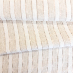 May include: A folded piece of fabric featuring a vertical striped pattern in alternating shades of beige and white. The design consists of solid white stripes paired with textured beige stripes that have a subtle, repeating dotted line detail.