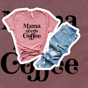 May include: A pink t-shirt with the text "Mama needs Coffee" in black lettering. The t-shirt is paired with blue jeans.