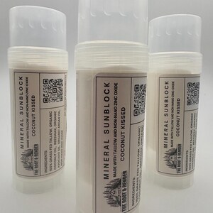 May include: Three white mineral sunblock sticks with clear caps. Each stick has a label with the text "MINERAL SUNBLOCK" and "COCONUT KISSED". The labels also list ingredients and the brand "THE ROOT & RENDER".