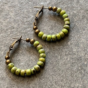 Green marbled hoop earrings with glass beads