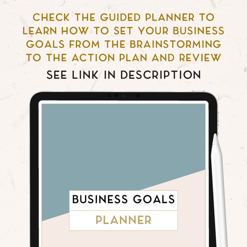 May include: A digital tablet displaying a business goals planner on the screen. The screen is divided into two sections, one light blue and the other cream. The text "BUSINESS GOALS PLANNER" is displayed in gold lettering on the cream section.