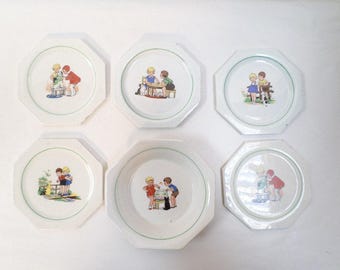 May include: Set of six white octagonal plates with a green rim and a central illustration of children. The illustrations depict children in various scenes, such as playing or interacting with each other. A vintage, collectible item.