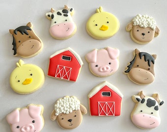 May include: A set of 12 decorated sugar cookies featuring farm animals, barns, and chicks. The cookies are decorated with colorful icing and details.