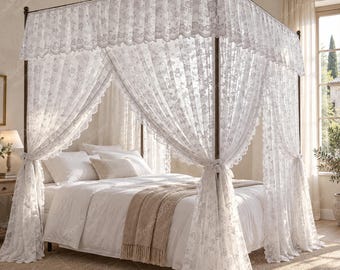 May include: A four-poster bed frame draped with white lace curtains featuring a floral pattern. The canopy top has a scalloped lace edge. The bed is dressed with white bedding, a beige throw blanket, and two pillows, set within a bedroom space.