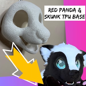 May include: A white 3D printed TPU base for a mask, featuring a textured surface and large eye openings. Next to it is a finished skunk mask with black and white faux fur and large blue eyes. The text reads RED PANDA & SKUNK TPU BASE.