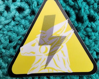 May include: Yellow warning triangle sticker with a white wolf head and a grey lightning bolt inside. The wolf's eyes are closed.
