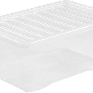 May include: A clear plastic storage box with a lid. The lid has a ribbed design.