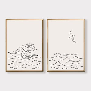May include: Two minimalist black and white line art prints with inspirational quotes about surfing. The first print features a wave and the text "You can't stop the waves". The second print features a seagull and the text "But you can learn to surf."
