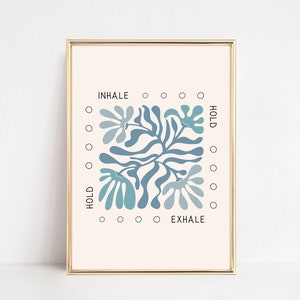 May include: A printable wall art print featuring a blue and white abstract floral design. The print includes the words "INHALE", "HOLD", and "EXHALE" around the design.