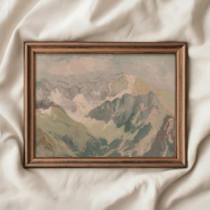May include: A framed landscape painting depicting a mountain range in muted greens, greys, and whites. The text "HEALING IS NOT LINEAR" is written across the top of the painting. The frame is a dark brown colour.