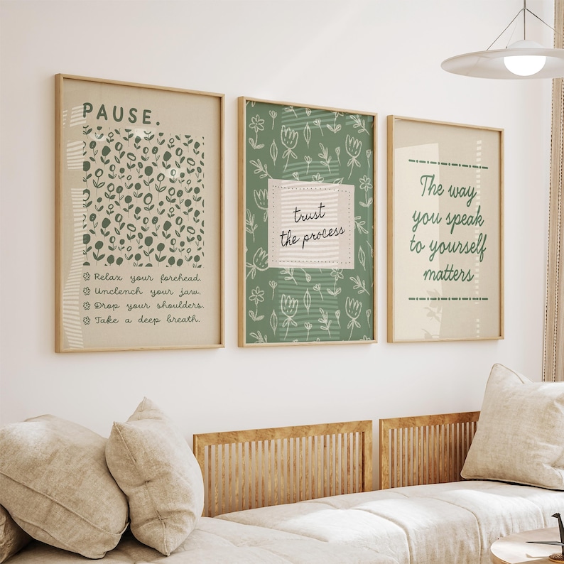 May include: Three framed art prints with inspirational quotes. The first print says "PAUSE" with instructions to relax. The second print says "trust the process". The third print says "The way you speak to yourself matters". All prints have a beige background and are in wooden frames.