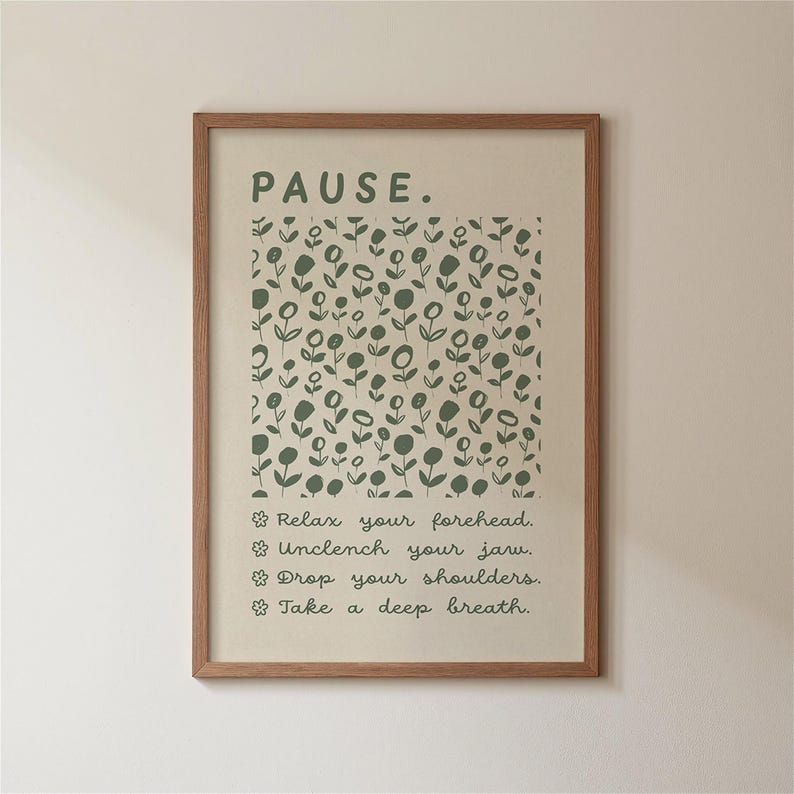 May include: A framed print with the word "PAUSE" in green above a floral pattern. Below, the print lists steps for relaxation: "Relax your forehead," "Unclench your jaw," "Drop your shoulders," and "Take a deep breath."
