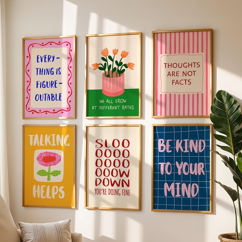 May include: A collection of six framed art prints with motivational quotes and illustrations. The prints display phrases such as "EVERYTHING IS FIGURE-OUTABLE" and "BE KIND TO YOUR MIND." The colour scheme includes pink, yellow, blue, and green.