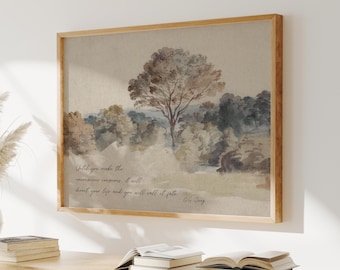 May include: A framed landscape art print featuring a tree and forest in muted tones of brown, green, and beige. The artwork includes a quote in a handwritten style font. The frame is made of light-colored wood.