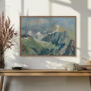 May include: A framed painting of a mountain range with a blue sky and white clouds. The text "Healing is not linear" is written across the top of the painting.