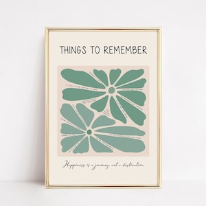 Op de afbeelding: Een printable wandposter met een groen bloemmotief en de tekst "Things to Remember" en "Happiness is a journey, not a destination". De poster toont een groene bloem met meerdere bloemblaadjes, elk met een positieve bevestiging.