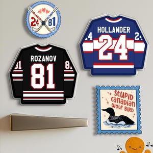 May include: A collection of hockey-themed magnets. Includes jersey-shaped magnets with player names and numbers, a round magnet with crossed hockey sticks, and a stamp-shaped magnet with a loon and the text "Stupid canadian WOLF BIRD."