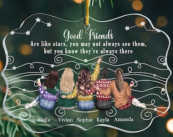 May include: A clear acrylic ornament with the text "Good Friends" and a quote about friendship. The ornament features illustrations of five friends, each with a name below. A gold string is attached for hanging.