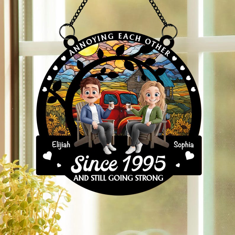 May include: Black metal sign with a chain for hanging. The sign features a couple sitting in chairs, a red truck, and the text "ANNOYING EACH OTHER" and "Since 1995 AND STILL GOING STRONG". The background shows a sunset and a house.