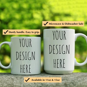 May include: Two white ceramic mugs with black text that reads "YOUR DESIGN HERE". The mugs are microwave and dishwasher safe and available in 11oz and 15oz sizes.