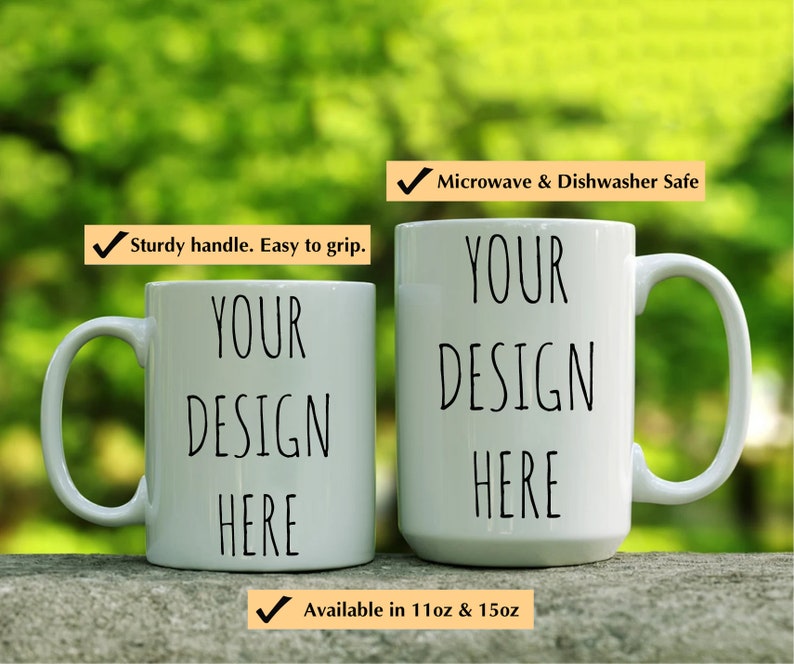 May include: Two white ceramic mugs with black text that reads "YOUR DESIGN HERE". The mugs are microwave and dishwasher safe and available in 11oz and 15oz sizes.