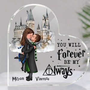 May include: Heart-shaped acrylic keepsake featuring a couple embracing in front of a castle illustration. The text reads "You Will Forever Be My Always" with the names "Mityam" and "Vincenzo" below. The couple is wearing scarves and robes.