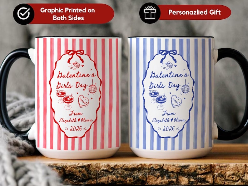 May include: Two ceramic mugs with black handles. One mug is red and white striped, the other is blue and white striped. Both mugs have a Valentine's Girls Day design with text and illustrations. The text reads "Dalentine's Girls Day" and "From Elizabeth & Olivia 2026".