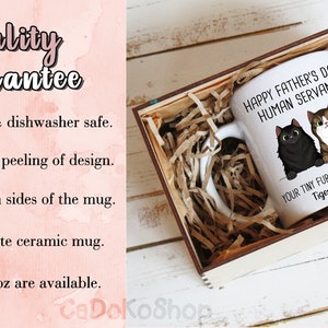 May include: White ceramic mug with a black and brown cat illustration. The mug reads "Happy Father's Day Human Servant" and "Your Tiny Furry Overlords Tiger & Mimir". The mug is in a wooden box with brown paper packing material.