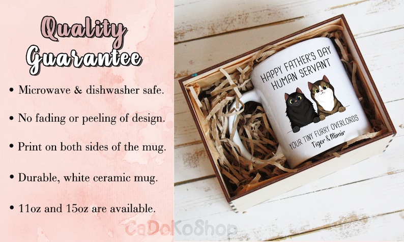 May include: White ceramic mug with a black and brown cat illustration. The mug reads "Happy Father's Day Human Servant" and "Your Tiny Furry Overlords Tiger & Mimir". The mug is in a wooden box with brown paper packing material.