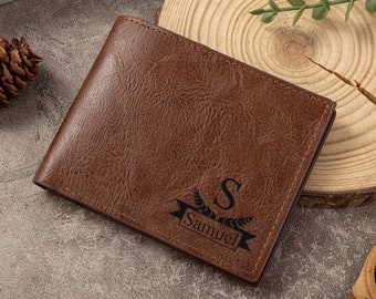 May include: A brown leather wallet with a personalized monogram. The monogram features the letter "S" with a wreath and the name "Samuel" underneath.