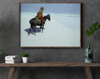 May include: Framed artwork showing a person on horseback in a snowy scene. The rider is dressed in a green shirt and brown trousers. The horse is black. The artwork is in a wooden frame and hangs on a grey wall.