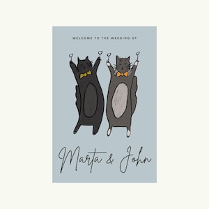May include: A wedding invitation featuring two cartoon cats toasting with champagne glasses. The cats wear bow ties and are set against a light blue background. The text reads "Welcome to the Wedding of Marta & John."