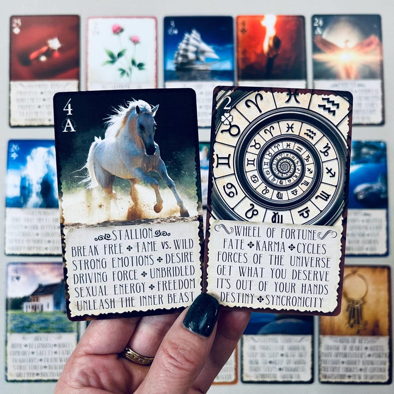 May include: Two tarot cards, one with a white horse running on a sandy beach and the text "Stallion" and the other with a circular design and the text "Wheel of Fortune".