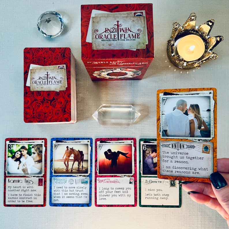 May include: A set of oracle cards with colorful backgrounds and images. The cards feature messages about love, trust, and growth. The cards are part of the 21 Win Oracle Flame deck.